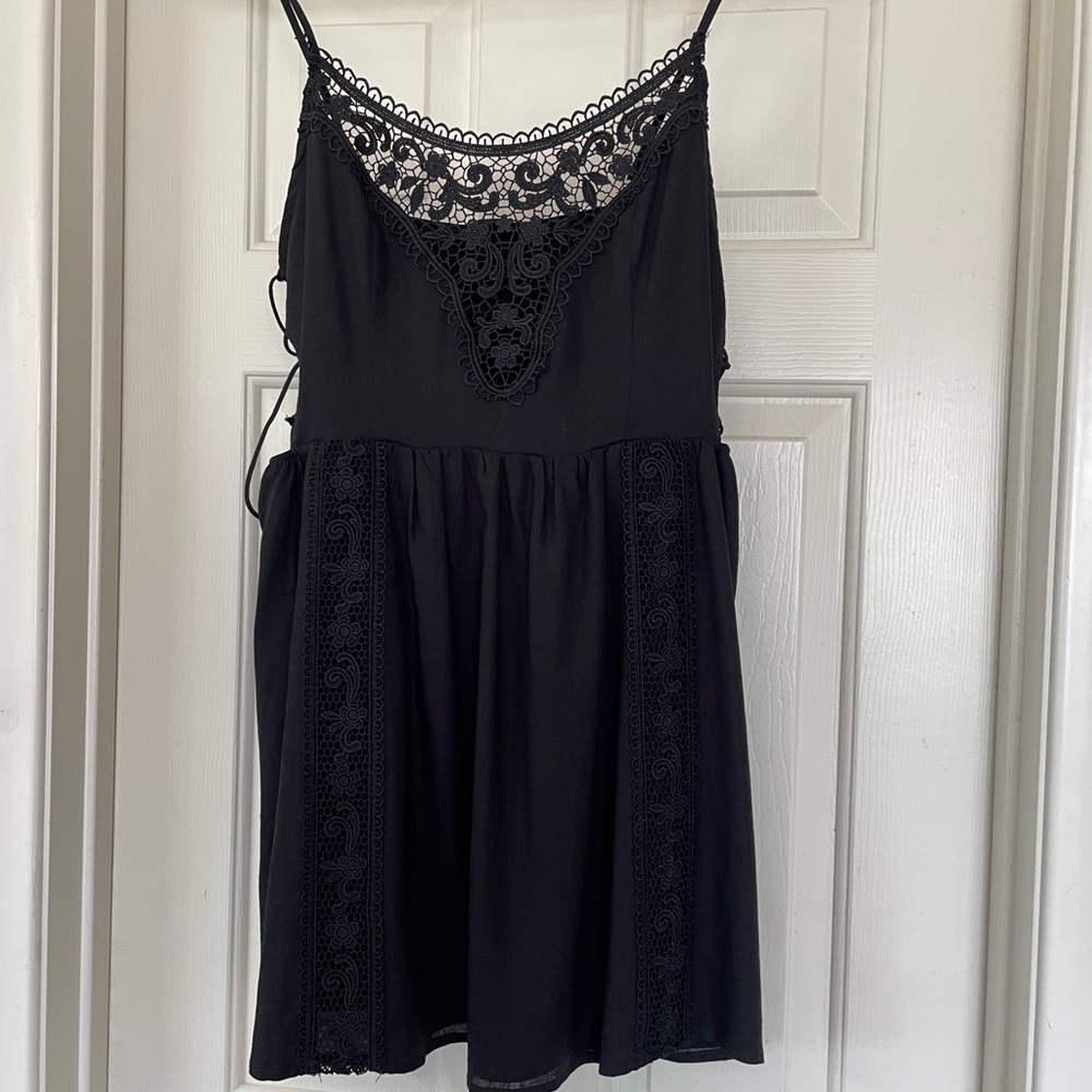 Black mini-dress with crochet detail/cut outs